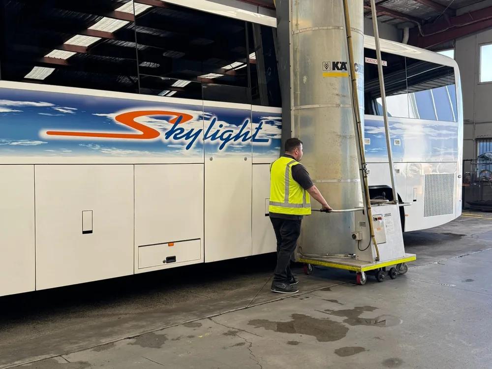 A Skylight Buslines coach being prepared inside the depot service bay