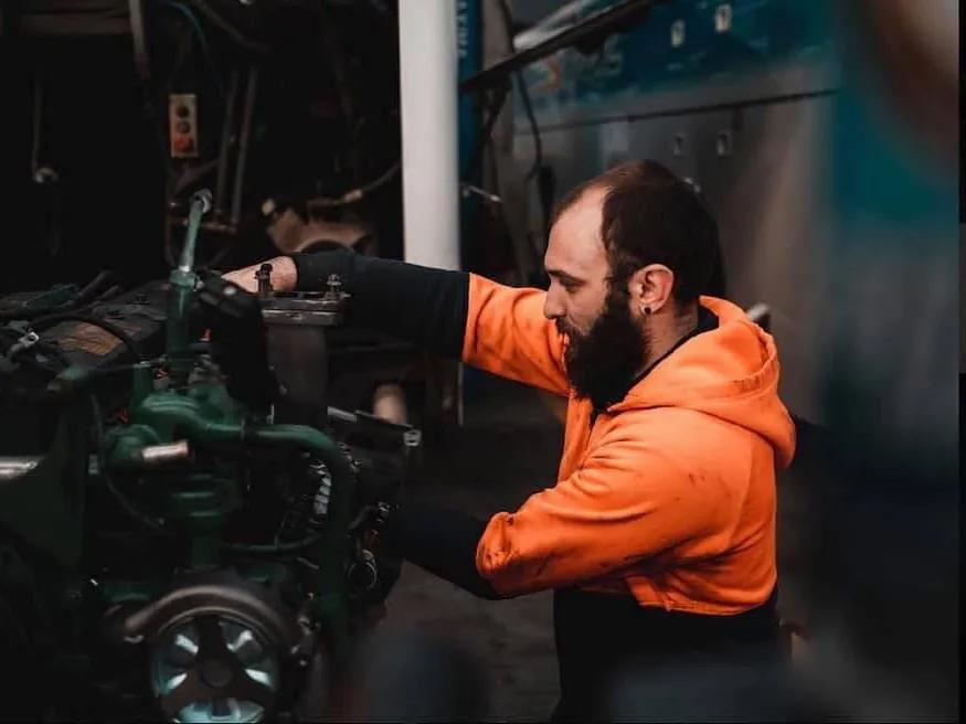 A Skylight Buslines mechanic servicing a coach in the company's own workshop